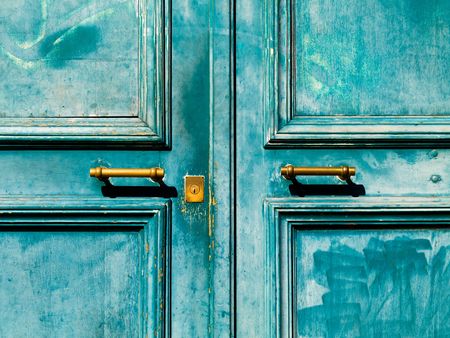 Turquoise vintage door with metal handle and keyholeの写真素材
