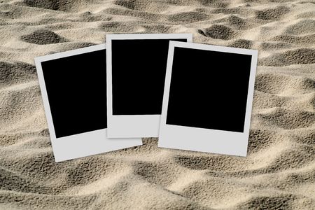 Set of three  blank photo films on sand backgroundの写真素材