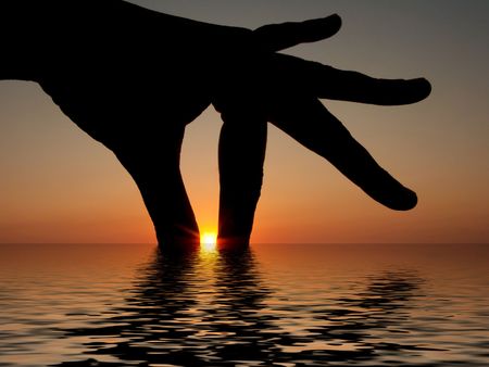 Silhouette of a female hand catching the sunset