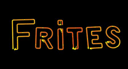 French fries red yellow neon sign on black backgroundの写真素材