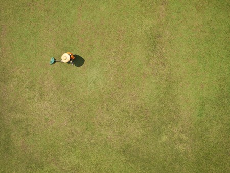 Bird view of a gardener working on grass in Malaysiaの写真素材