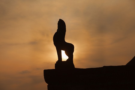 Lion statue at sunrise at Angkor Wat templeの写真素材