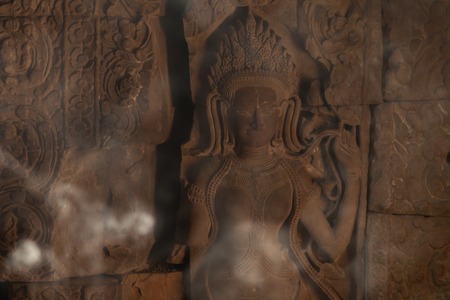 Devata carving with fumes in Preah Khan templeの写真素材