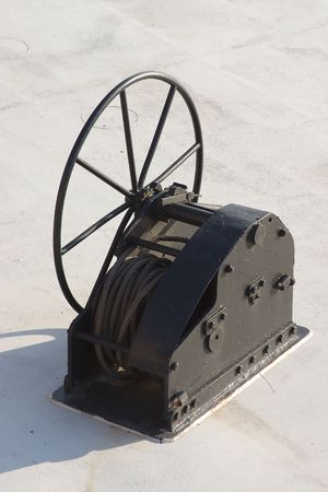 a boat winch with a wrapped black cable .