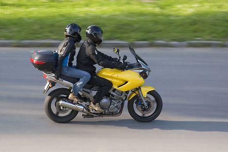 A young couple riding motorbike in high speed.の写真素材