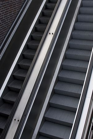 a pair of escalators in underground entrance.