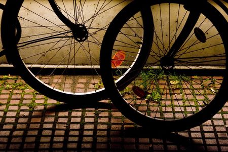 silhouette of bicycles wheels at night light.