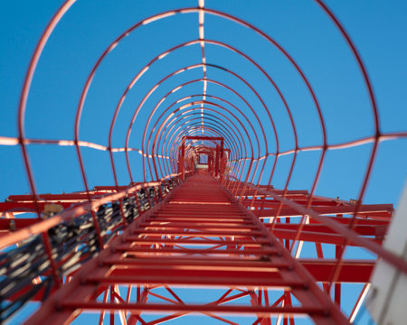 Red ladder for climbing the communication towerの写真素材