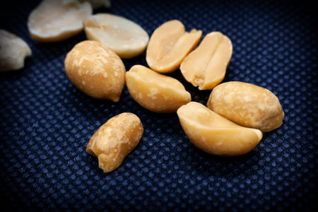 Photo of a handful of peanuts on a dark backgroundの写真素材
