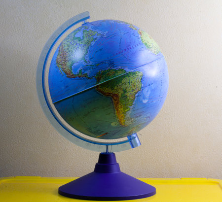 desktop globe on the table. Geography at school