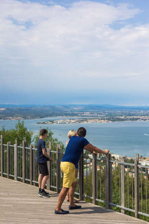Tourists looking at the sea from the top of the observation deck