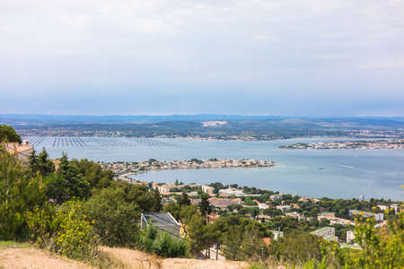 Panoramic view of a coastal town from the hillの写真素材
