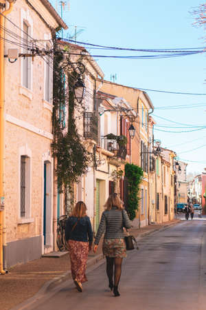 Two women walking on the streets of Lisbon, Portugalの写真素材