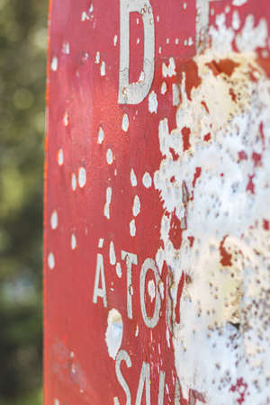 Abandoned red road sign with the word attention on it.の写真素材