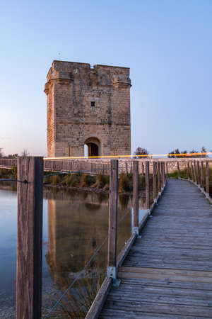 A vertical shot of a wooden bridge leading to the tower of the castleの写真素材
