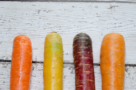 Colorful organic rainbow carrots on wooden background.の写真素材