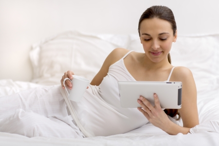 Pretty woman surfing on the internet at homeの写真素材