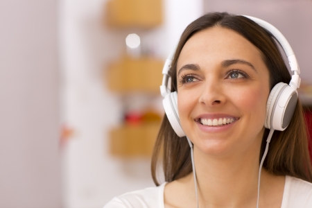 Pretty female with white headphones on headの写真素材