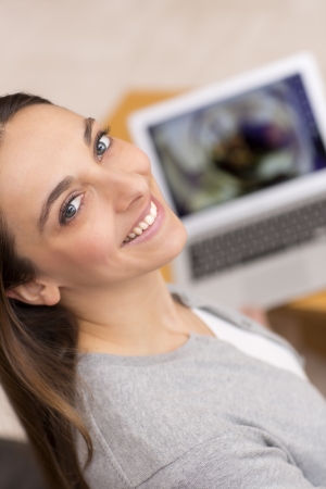 Female looking at pictures on her computerの写真素材