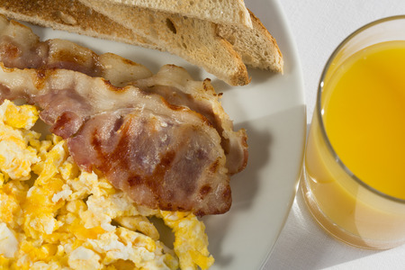 Sunny Breakfast with bacon, eggs and bread.の写真素材