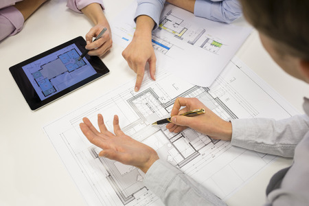 Business team desk architect man woman digital tablet blueprint constructionの写真素材