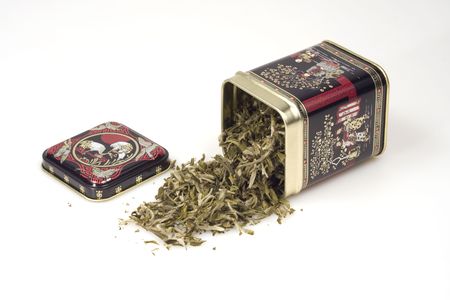 Close-up shot of a tin can and green tea leavesの写真素材