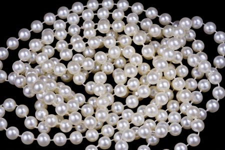 Close up shot of a white pearl necklace over black backgroundの写真素材