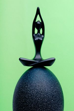 Figurine of the meditating woman on ostrich eggの写真素材