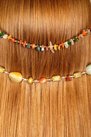 Background from red hair with jewelryの写真素材