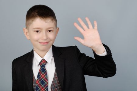 Boy waves a hand, welcoming you