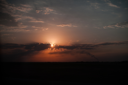 Sunset over clouds in shades of redの写真素材