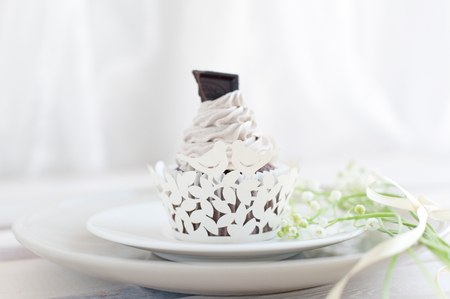 Wedding cupcake with white cream and dark chocolate for dessertの写真素材