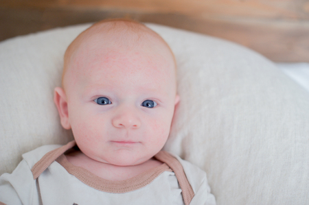 Newborn baby with a slight smile on his faceの写真素材