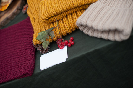 Knitted cap and snuff on the tableの写真素材