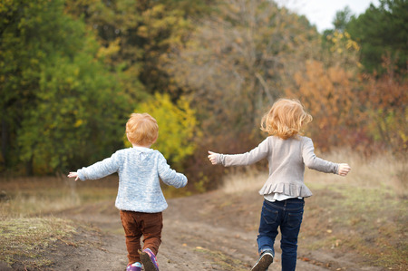 Red children run down the hillの写真素材