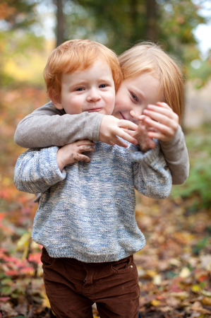 Children playing in the autumn forestの写真素材
