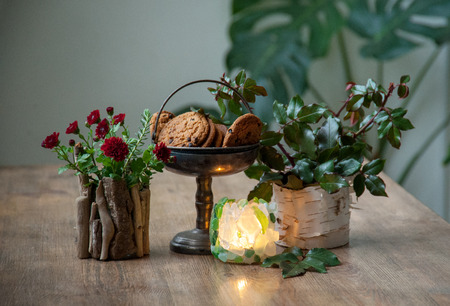 Cookies in an old vase on a wooden table