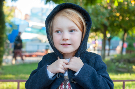 Girl with a hood on her head in the parkの写真素材