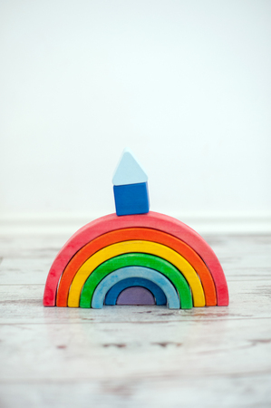 A wooden rainbow with a cubbyhole on itの写真素材