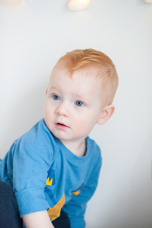 Boy with bright blue eyes closeupの写真素材