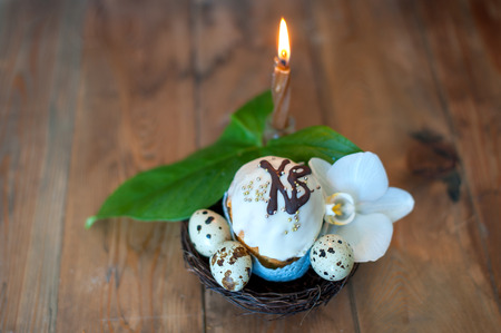 Easter cake, eggs and a candle