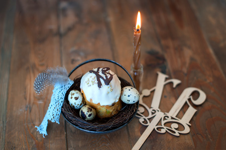 Easter cake, eggs and a candle