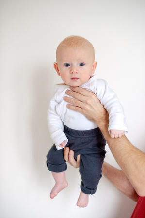 Three-month-old baby in male hands