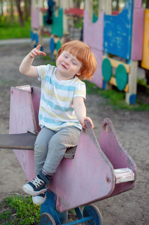 The boy plays in the playgroundの写真素材