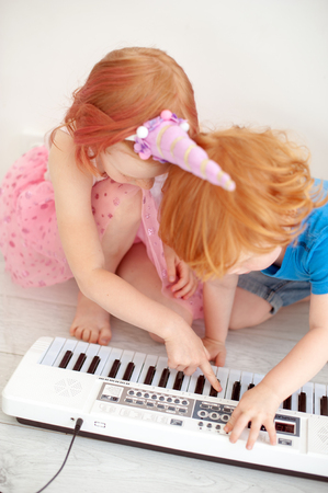 Children play with electronic pianoの写真素材