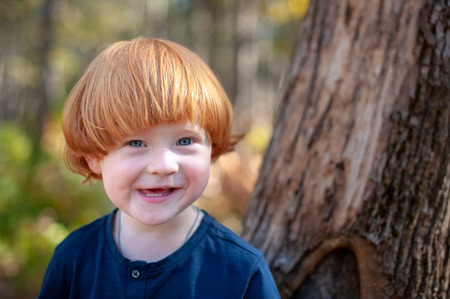 Red-haired boy smiles funnyの写真素材