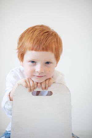 Funny red-haired boy in a white shirtの写真素材