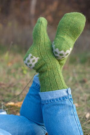Handmade knitted socks on the background of natureの写真素材