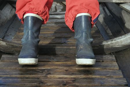 rubber boot detail in an old vintage fishing boat.の写真素材