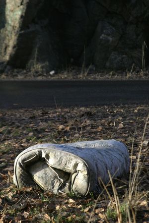 Old Mattress in a bed of leavesの写真素材